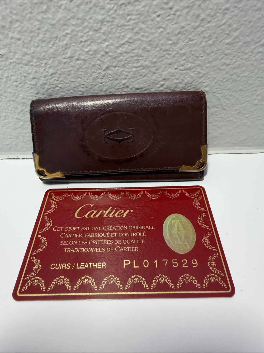 Cartier Brownish Red Leather Card Holder with Gold Corner Accents